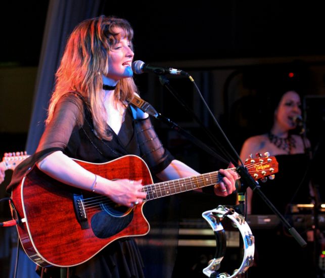 Heather playing acoudtic guitar