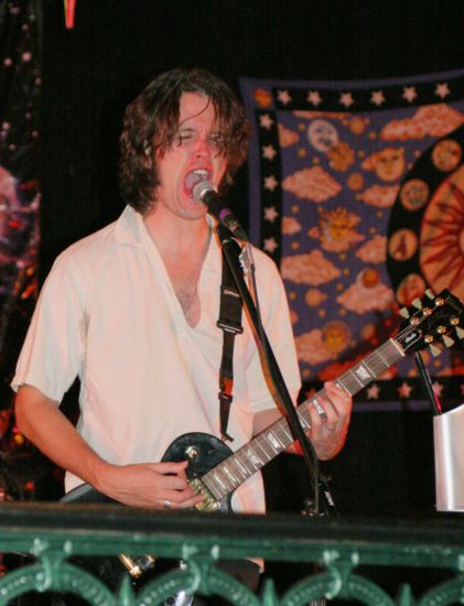 Luiz roaring and playing guitar