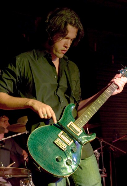 Luiz playing guitar with a whistle
