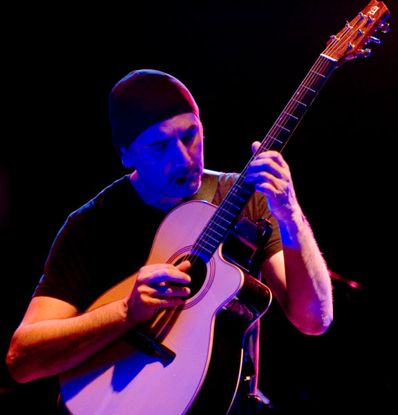 Enrico playing acoustic guitar